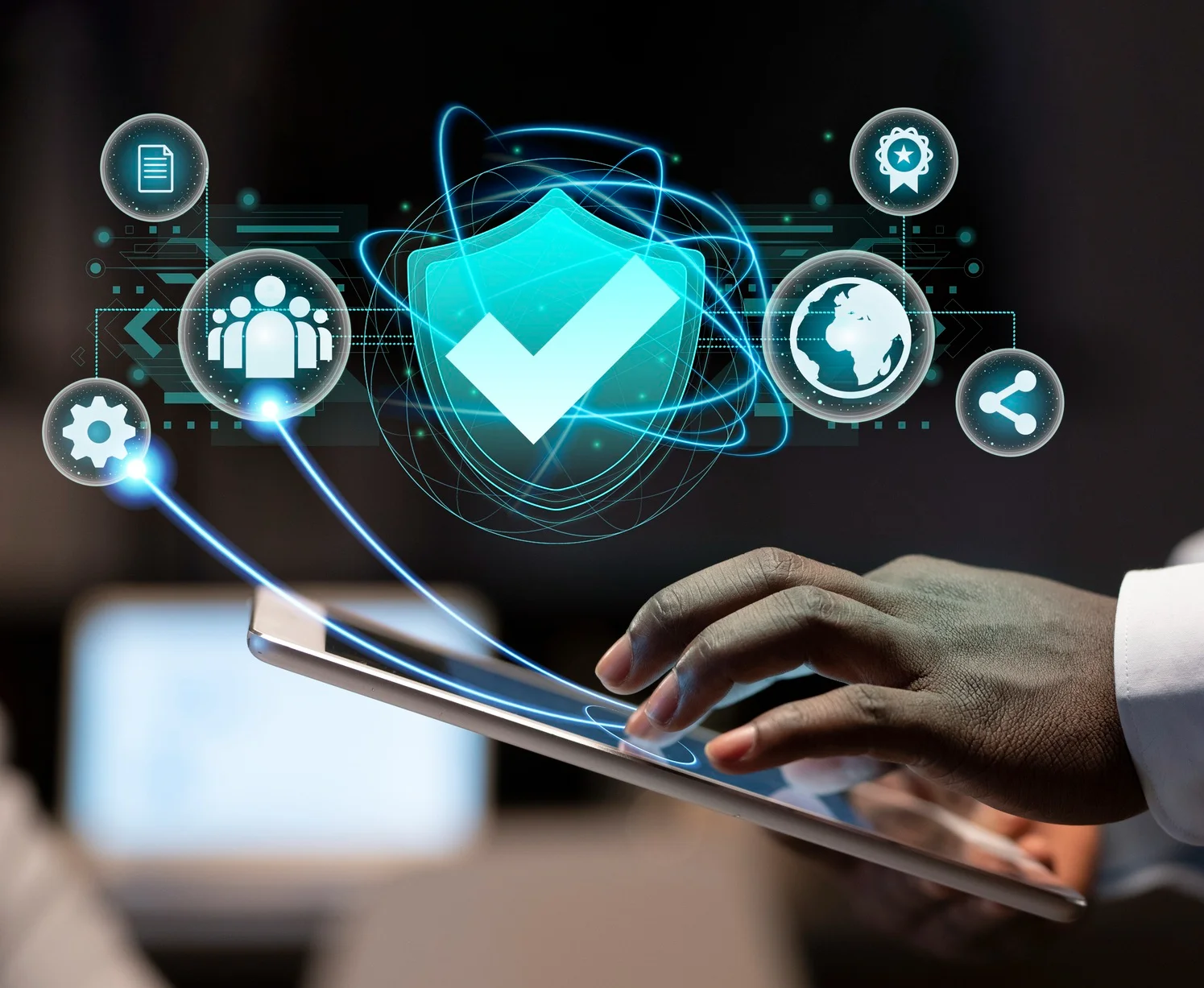 Professional holding a digital tablet with hovering cybersecurity icons, symbolizing layered digital protection and proactive defense.